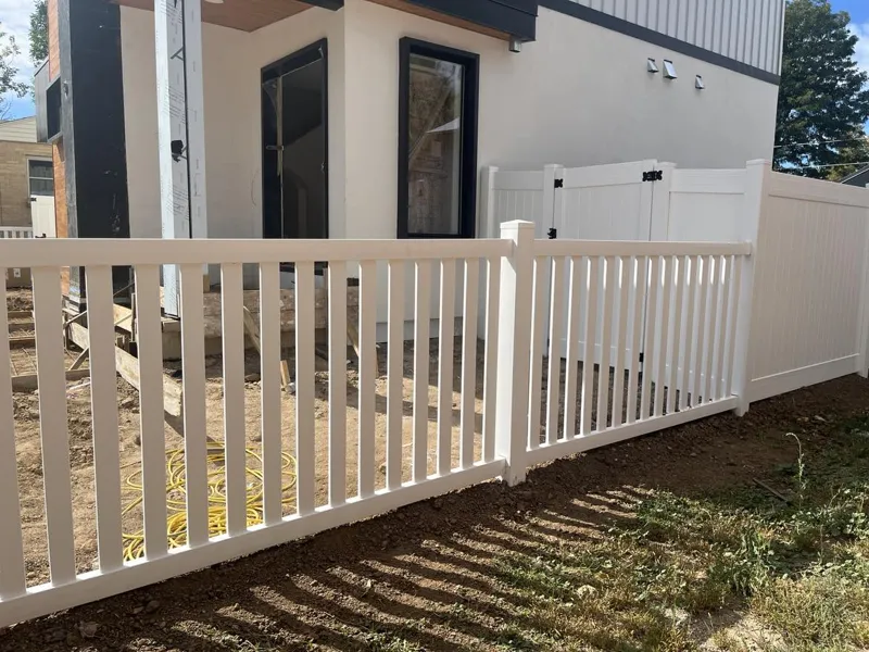 White vinyl fence along a yard