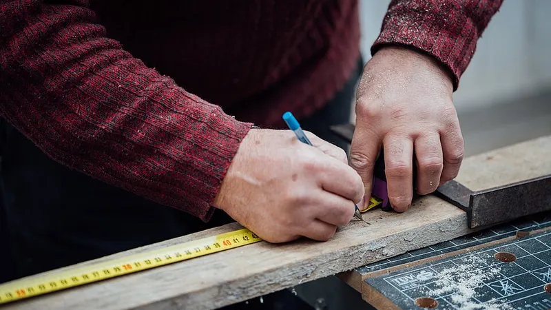 Handyman measuring and marking a board