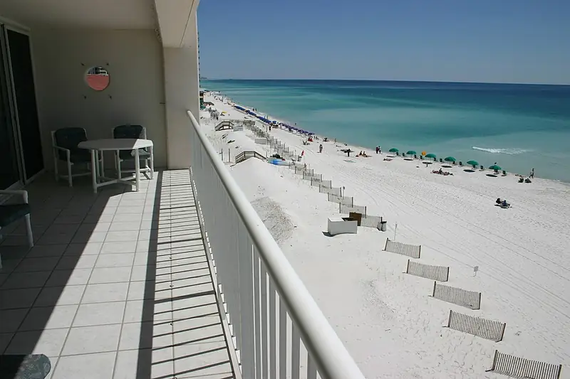 Balcony view over a white Gulf beach